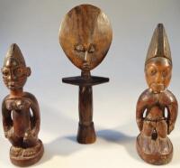 A pair of Yoruba male and female carved wooden figures and an Ashanti fertility doll