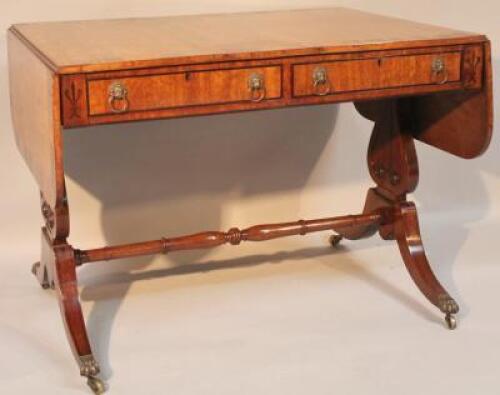 A Regency mahogany drop leaf sofa table with a wide Coromandel cross banding