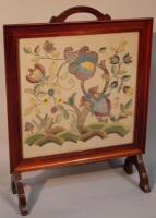 A 20thC fire screen with embroidered floral panel