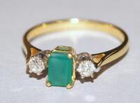 An 18ct gold emerald and diamond ring.