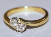 An 18ct diamond 2 stone twist ring