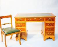 A Bevan Funnel Reprodux yew finished twin pedestal kneehole desk