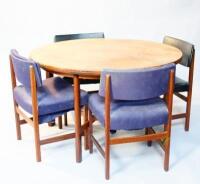 A 1970s teak circular extending dining table and six chairs.