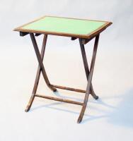 A Victorian folding card table. With splayed legs and turned stretchers.