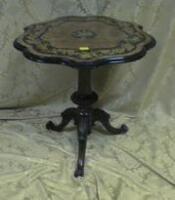 A mid Victorian walnut tripod table with shaped top laid in burr veneers