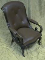 A Victorian mahogany open armchair with brown studded vinyl upholstery