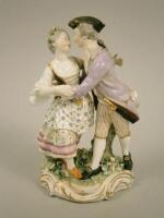 An early 19thC Derby porcelain figure group of a gentleman and a lady