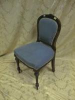 A Victorian walnut spoonback side chair with overstuffed seat and turned forelegs