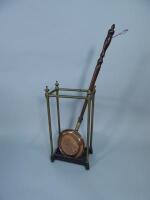 An Edwardian brass and iron umbrella stand