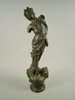 A reproduction bronze effect statue of an armless male figure