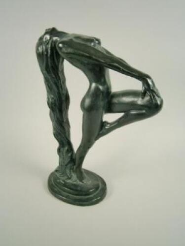 A bronzed composition figure of a nude with long hair