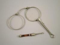 A white metal lorgnette and a small button hook with agate handle