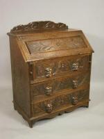 A Victorian carved oak bureau