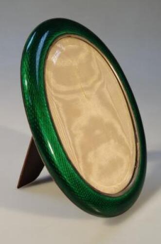 An Edwardian green enamel and white metal photograph frame