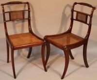 A pair of Regency mahogany and brass inlaid brass bergere occasional chairs