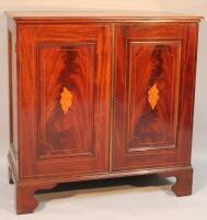 An Edwardian flame mahogany freestanding cupboard