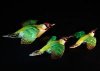 A set of three Beswick flying green woodpeckers.