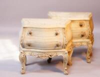 A pair of painted bedside tables