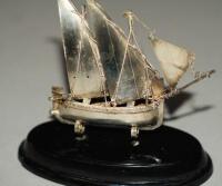 A silver model of a sailing ship