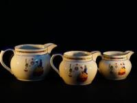 A set of three graduated jugs