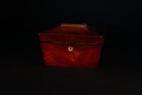 A Victorian sarcophagus shaped rosewood tea caddy.