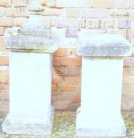 A pair of stone pedestals