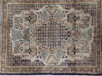 A small Eastern bordered silk rug