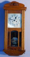 An early 20thC oak cased wall clock