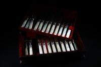 A twelve piece silver plated and mother of pearl dessert knives and forks