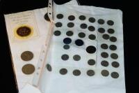 A folder of coins including various crowns