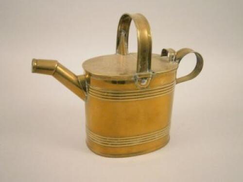 A brass watering can