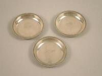 A set of three white metal pin trays