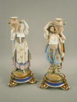 A pair of French porcelain candlesticks