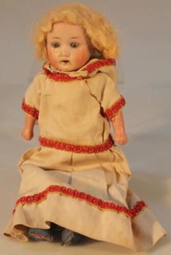 A late 19thC Continental bisque headed doll