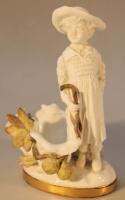 A late 19thC Moore Brothers figure group of a child in flowing robes