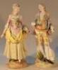 A near matching pair of Continental porcelain figure groups