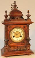 An early 20thC continental oak cased mantel clock