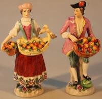 A pair of Sitzendorf figures of fruit sellers