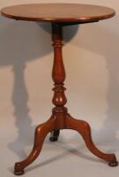 A mahogany oval snap top occasional table