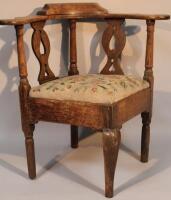 An early 19th century oak corner chair