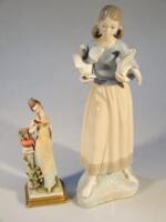 A Lladro style figure of a girl holding two birds