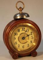 An Edwardian oak cased circular alarm clock