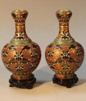 A pair of cloisonne vases each of circular form with inverted and highlighted stems and bulbous bodi