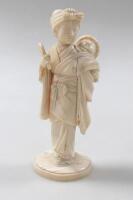 A Japanese carved ivory okimono figure