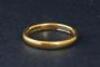 An 18ct gold wedding band