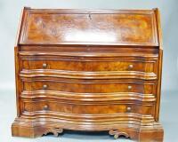 A Continental mahogany serpentine fronted bureau