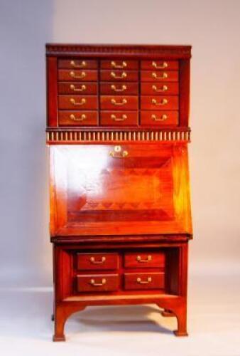 A 20thC stained oak secretaire/cabinet