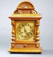 An early 20thC Continental oak mantel clock