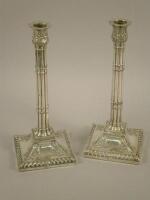 A pair of George III silver candlesticks