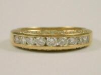 An 18ct gold diamond channel set ring